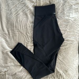 MICHI leggings with mesh paneling on the thighs and calves.